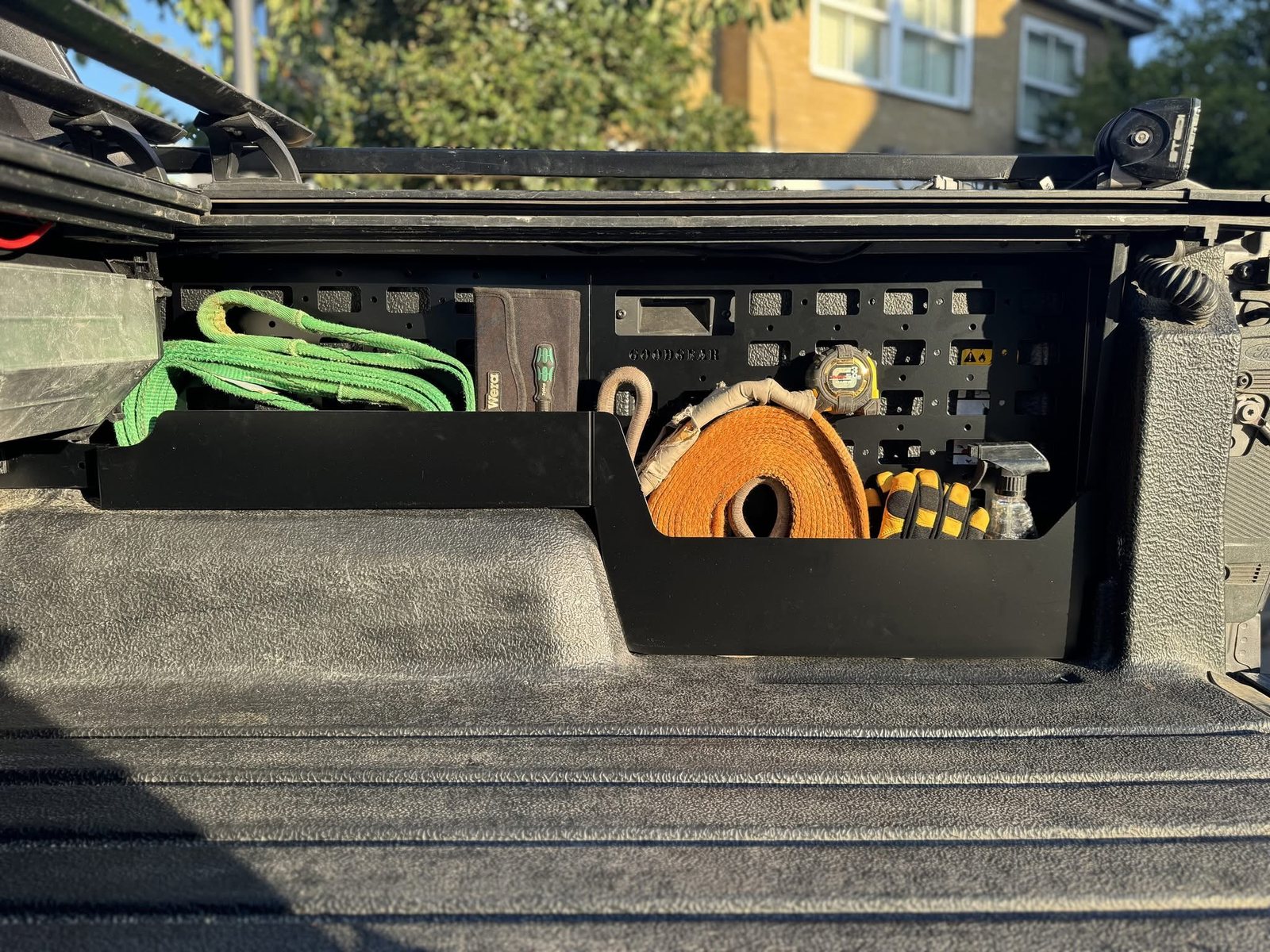 Storage rack in use, holding recovery straps and tools